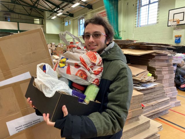 Student Jakob Romanowski packing a van-load of donations for Ukrainian refugees